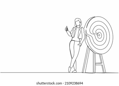 Continuous one line drawing happy businesswoman or manager is standing or leaning the target with thumbs up gesture. Arrow hit the target exactly. Single line draw design vector graphic illustration