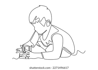 Continuous one line drawing happy boy playing puzzle box. Happy Children's Day concept. Single line draw design vector graphic illustration.