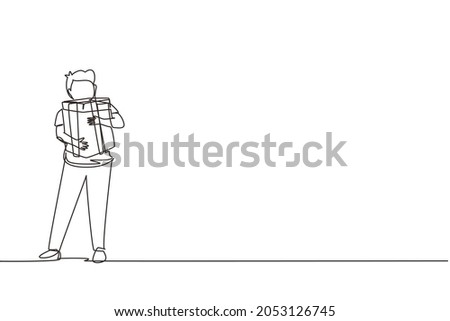 Continuous one line drawing kid standing and hugging ribbon bow wrapped gift box in front of his in arms. Cute little boy carries holiday gift box with bow in his hands. Single line draw design vector