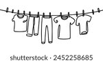 Continuous one line drawing of laundry hang on clothline. Vector illustration