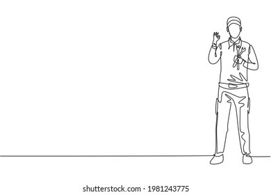 Continuous one line drawing male mechanic stands up with gesture okay and holding wrench to perform maintenance on vehicle engine. Success business. Single line draw design vector graphic illustration