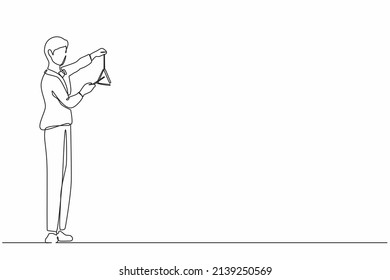 Continuous one line drawing male musician playing musical triangle. Classical music orchestra man artist with music instrument. Professional musician performs on stage. Single line draw design vector