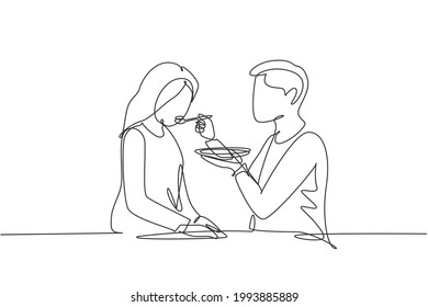 Continuous one line drawing romantic male feeds his wife. Happy young couple having dinner together at restaurant. Celebrate wedding anniversaries. Single line draw design vector graphic illustration