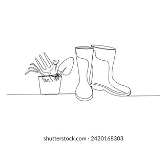 Continuous one line drawing of Rubber boots and Gardener equipment in bucket. Shovel, rake, glove in bucket single outline vector illustration. Editable stroke.