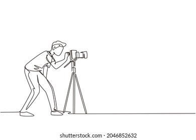 Continuous one line drawing super equipment photographer, Man holding, aiming cameras with standing tripod, Carrying accessories for photographing. Single line draw design vector graphic illustration