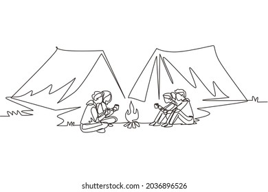 Continuous one line drawing two couple camping around campfire tents. Group of man woman sitting on ground and drinking hot tea getting warm near bonfire. Single line draw design vector illustration