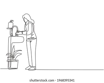 Continuous one line drawing a woman washes her hands in the sink, there is a soap dish by the tap and there is a pot of plants under the sink. Single line draw design vector graphic illustration.
