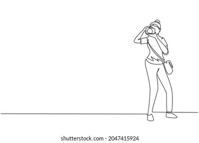Continuous one line drawing woman with camera and sling bag taking pictures. Female paparazzi or journalist occupation, digital photography hobby activity. Single line draw design vector illustration