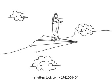 Continuous one line drawing young Arab male worker standing and holding laptop on flying paper plane. Business manager minimalist metaphor concept. Single line draw design vector graphic illustration