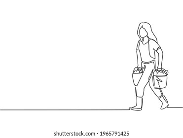 Continuous one line drawing young female farmer carrying boxes and baskets of fruit in her right and left hands. Success farming minimalist concept. Single line draw design vector graphic illustration