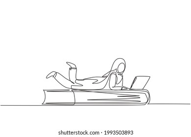 Continuous one line drawing young Arab female with laptop laying down on big book. Freelance, distance learning, online courses, studying concept. Single line draw design vector graphic illustration