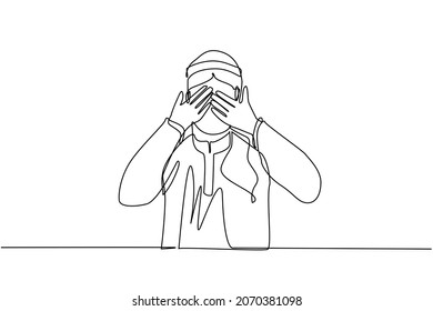 Continuous one line drawing young Arabian man closes his eyes with his hands because of disgust and reluctance to see something, fear or sadness isolated. Single line draw design vector illustration