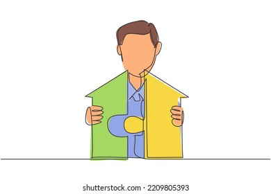 Continuous one line drawing young handsome male worker arrange piece of puzzle into house building. Success business manager minimalist concept. Single line draw design vector graphic illustration