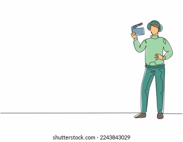 Continuous one line drawing of young talented male film director pose standing at shooting location. Professional job profession minimalist concept. Single line draw design vector graphic illustration