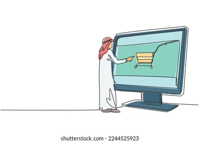 Continuous one line drawing young Arabian man shopping through monitor screen with shopping cart. E-shop, e-commerce, digital lifestyle concept. Single line draw design vector graphic illustration