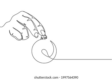 Continuous one line of hand holding christmas bauble in silhouette on a white background. Linear stylized.Minimalist. Happy New Year 2022 concept