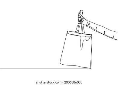 Continuous one line of hand holding eco bag in silhouette on a white background. Linear stylized.Minimalist.