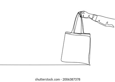 Una línea de mano continua sosteniendo una bolsa ecológica en silueta sobre un fondo blanco. Linear estilizado.Minimalista.