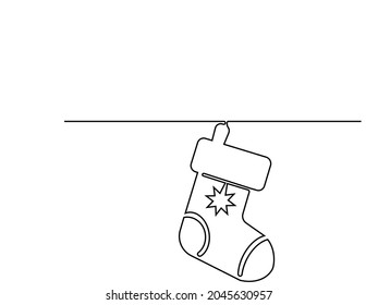 Continuous one line of hanging christmas sock in silhouette on a white background. 