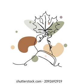 Continuous one simple single line drawing of hand holding autumn leaf maple in silhouette on a white background. Linear stylized.