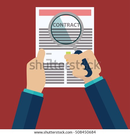 Contract inspection concept - Hand holding magnifying glass over a contract