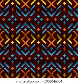Contrast colorful knitted seamless pattern in orange, blue, orange and yellow tones on the dark red background, vector pattern as a fabric texture