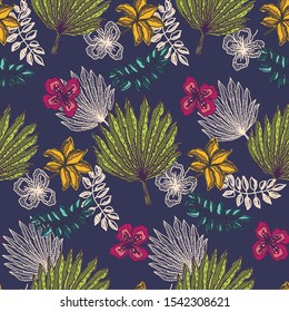 Contrast seamless pattern with colorful tropical leaves and flowers on dark blue background. Trendy exotic plants texture for textile, wrapping paper, surface design, wallpaper