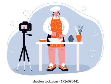 Cook prepares a pie. A happy chef in an apron, a blogger, prepares homemade dough or pastries. He's 
being filmed by a talk show camera. Smiling girl prepares a dessert at the kitchen table, isolated