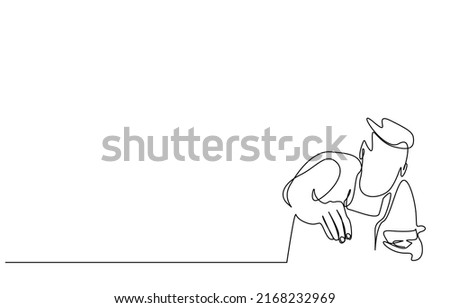 A cook in a professional uniform adjusts the salt and seasoning of the food and adds