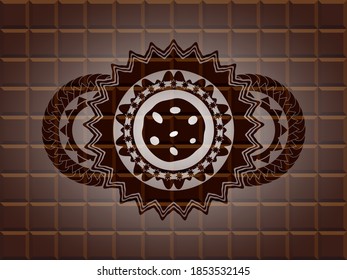 cookie icon inside chocolate realistic emblem. Brown fashionable background. Vector illustration. 
