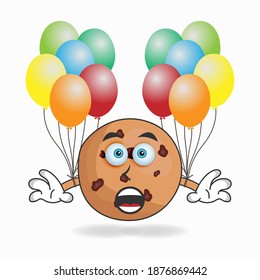 Cookies mascot character holding a balloon. vector illustration