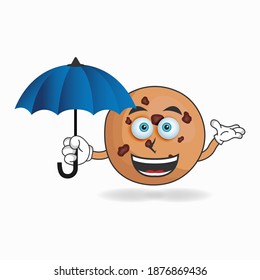 Cookies mascot character holding an umbrella. vector illustration