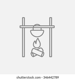 Cooking in cauldron on campfire line icon for web, mobile and infographics. Vector dark grey icon isolated on light grey background.