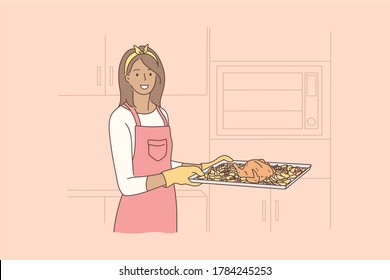 Cooking, food, hobby, housework concept. Young happy smiling african american woman housewife holding hot tray baked chicken with oven gloves looking at camera. Domestic chores and healthy lifetyle.