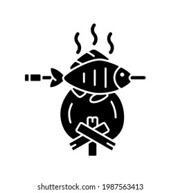Cooking freshly caught fish black glyph icon. Fres sea food idea. Hobby and leasure activities. Making a fire. Outdoor cooking. Silhouette symbol on white space. Vector isolated illustration