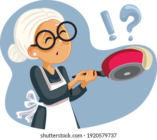 Cooking Granny Failing to Flip a Pancake. Senior woman making pancakes feeling disappointed
