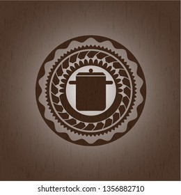 cooking pot icon inside realistic wood emblem