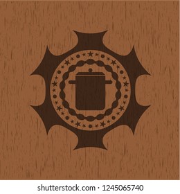 cooking pot icon inside wood badge or emblem