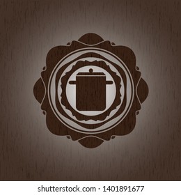 cooking pot icon inside wooden emblem. Vintage.