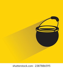 cooking pot with shadow on yellow background