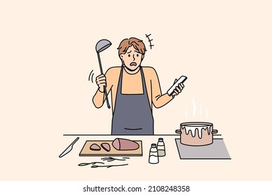 Cooking and preparing food concept. Young confused man in apron standing trying to cook soup boiling and holding smartphone with recipe in hand vector illustration 