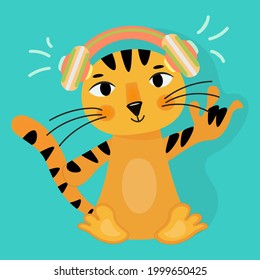 Cool cartoon tiger cub wearing headphones with thumb up. The character, satisfied with life, shows with a gesture that everything is cool. The tiger is a symbol of 2022. Vector on green background.