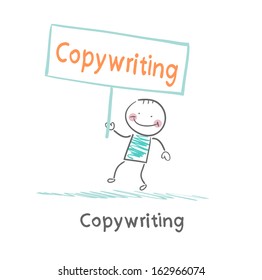 Copywriter holding a sign saying that it advertises