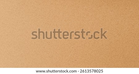 Cork texture background - grainy light brown natural material surface. Bulletin board, memo board substrate, notice wall covering. Organic pattern for interior design. Eco-friendly renewable material.