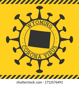 Corona virus in Wyoming sign. Round badge with shape of virus and Wyoming map. Yellow us state epidemy lock down stamp. Vector illustration.