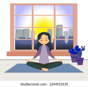 Coronavirus quarantine yoga classes at home. girl sits pose meditation in an apartment, against, background of a window, city, sun.  yoga concept. Kovid-19 virus - closing gyms of fitness centers