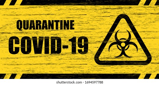 Coronavirus warning sign. Scratched wooden plate with the inscription Quarantine COVID-19 and biohazard symbol in yellow and black colors