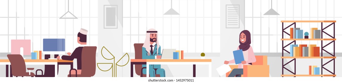 corporate staff employees working in creative co-working open space arabic coworkers businesspeople sitting at workplace and discussing new project modern office interior portrait horizontal