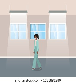 corridor with black businesswoman walking