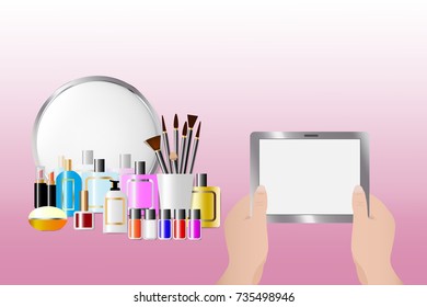 Cosmetic accessories standing in front of a mirror on the pink  background. Female hands are holding a tablet with empty screen ready for your text. All potential trademarks are removed.